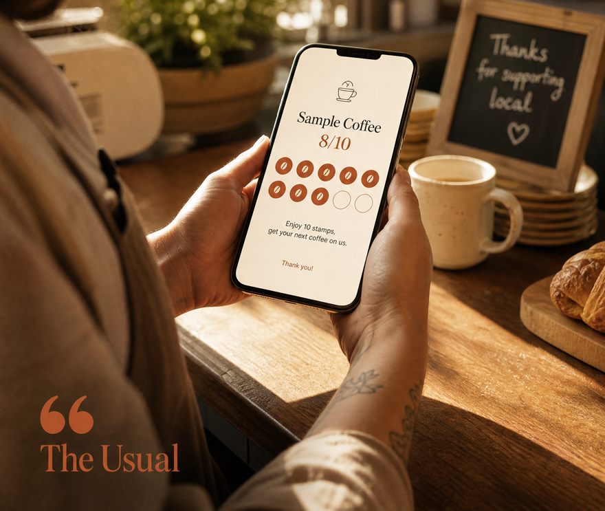 A barista holding a phone showing a Sample Coffee loyalty card at 8 of 10 stamps